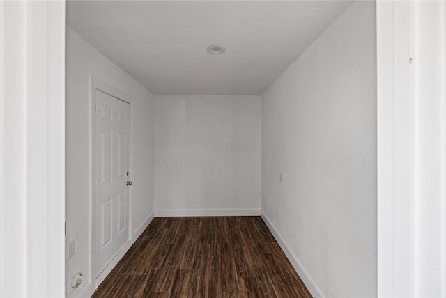 interior space featuring dark wood-style floors and baseboards