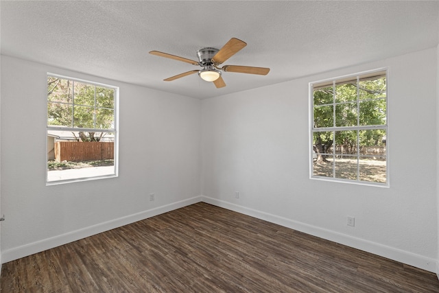 unfurnished room featuring a textured ceiling, ceiling fan, dark wood finished floors, and baseboards