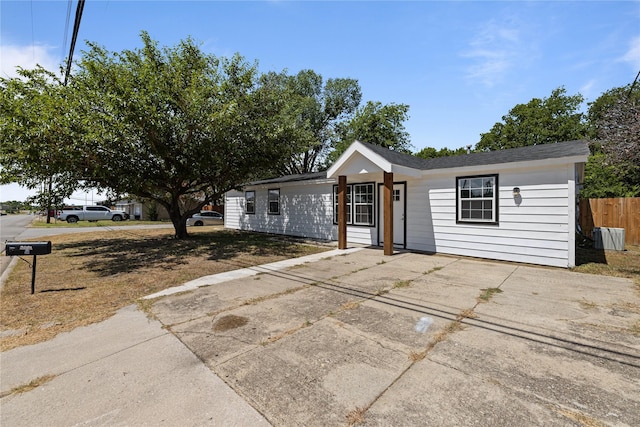 ranch-style house with fence