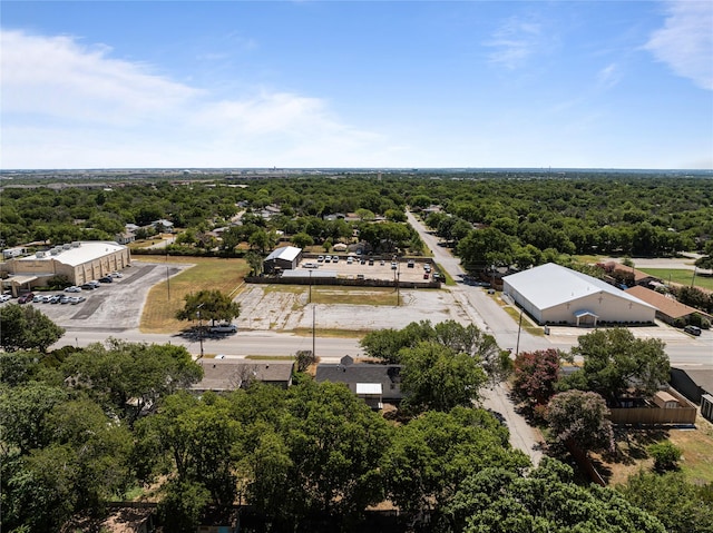 drone / aerial view with a wooded view