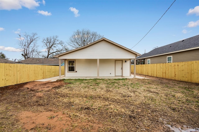 back of property with a fenced backyard