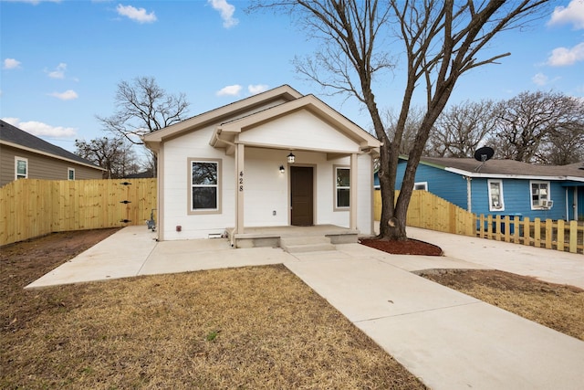 view of front of house with crawl space and fence