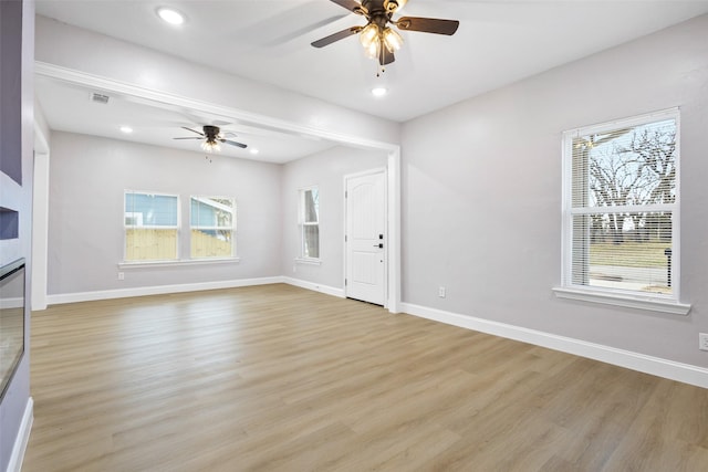 unfurnished living room with a ceiling fan, recessed lighting, light wood-style flooring, and baseboards