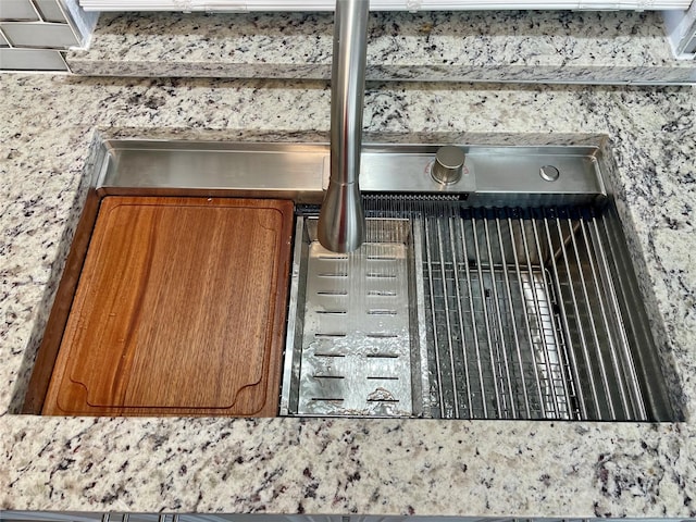 details featuring brown cabinets and a sink