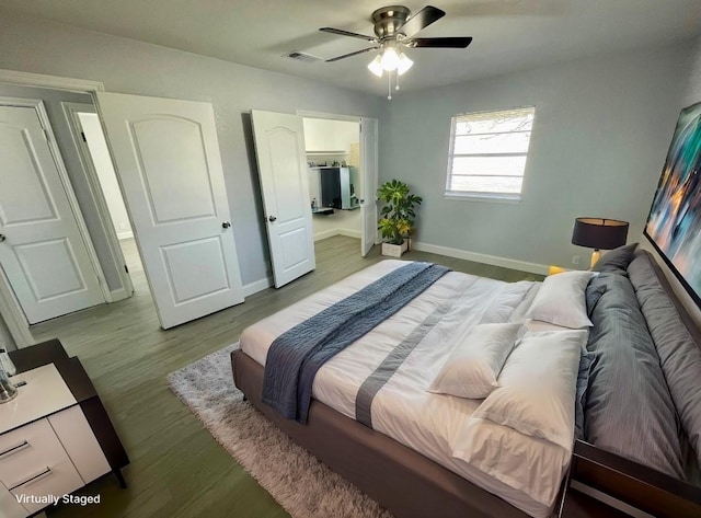 bedroom featuring baseboards, light wood-type flooring, and ceiling fan