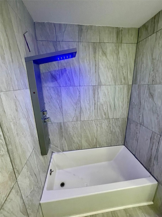 bathroom with a shower, a bath, and tile walls