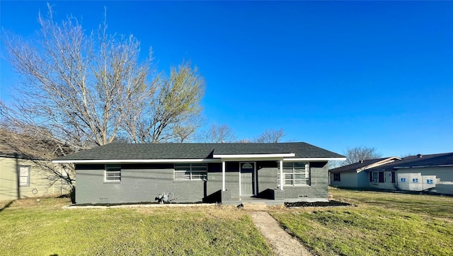 single story home featuring a front lawn, crawl space, a shingled roof, and brick siding