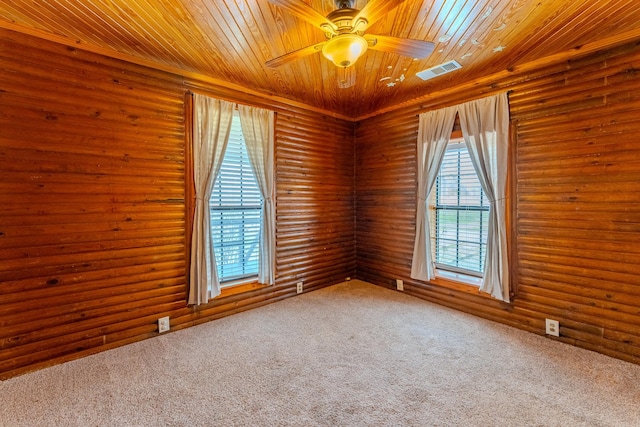 empty room with carpet floors, wood ceiling, visible vents, and ceiling fan