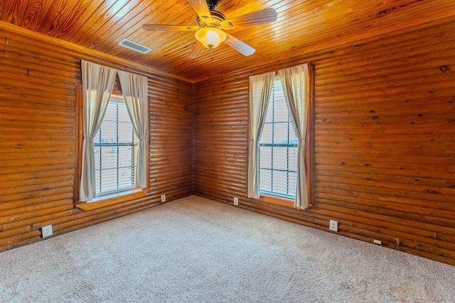 carpeted spare room featuring wooden ceiling, visible vents, and a ceiling fan