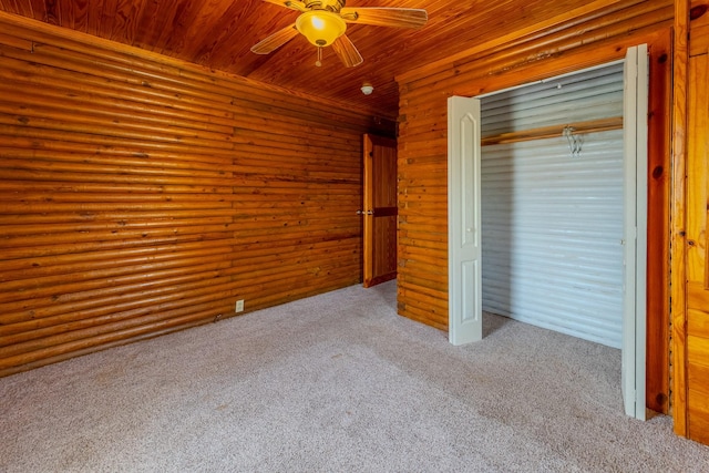 unfurnished bedroom with ceiling fan, a closet, carpet, and wooden ceiling