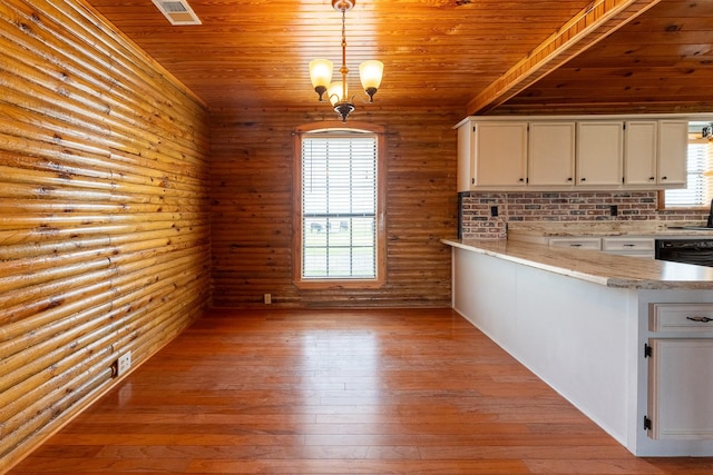 kitchen with light countertops, wooden ceiling, white cabinetry, and light wood-style floors