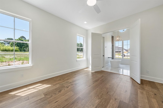 4618 Flat Creek Cv, Tyler, TX 75703 - spare room with plenty of natural light, wood finished floors, a ceiling fan, baseboards, and lofted ceiling