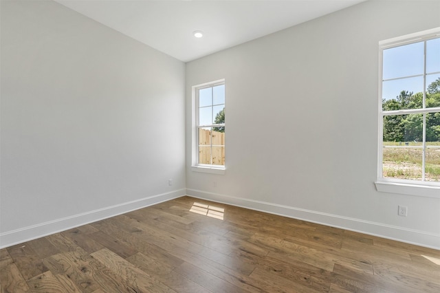 4618 Flat Creek Cv, Tyler, TX 75703 - unfurnished room with baseboards, healthy amount of natural light, and wood-type flooring