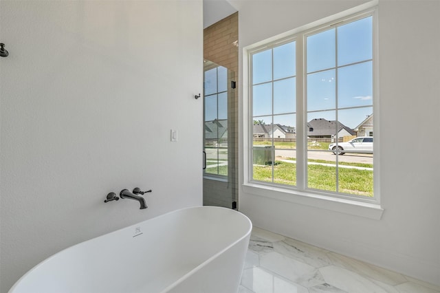 4618 Flat Creek Cv, Tyler, TX 75703 - bathroom with a freestanding bath, marble finish floors, a shower with shower door, and a residential view