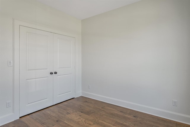 4618 Flat Creek Cv, Tyler, TX 75703 - unfurnished bedroom with dark wood-style flooring, baseboards, and a closet