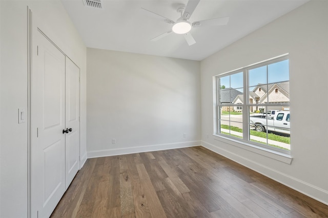 4618 Flat Creek Cv, Tyler, TX 75703 - unfurnished bedroom featuring baseboards, wood finished floors, a closet, and a ceiling fan