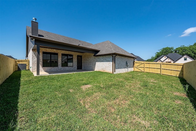 4618 Flat Creek Cv, Tyler, TX 75703 - back of house with a chimney, brick siding, a patio area, and a shingled roof