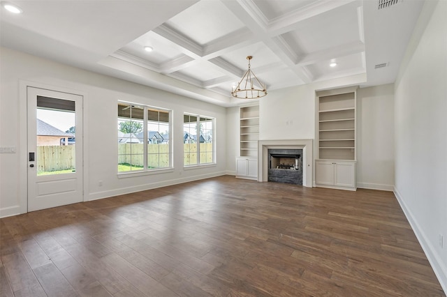 4618 Flat Creek Cv, Tyler, TX 75703 - unfurnished living room featuring a chandelier, dark wood-style flooring, baseboards, built in features, and beamed ceiling
