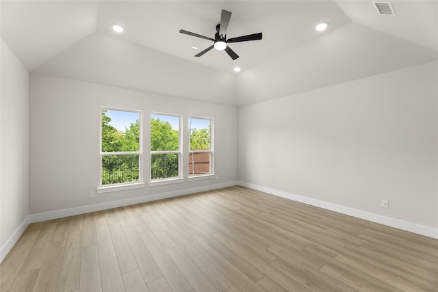 unfurnished room featuring ceiling fan, light wood-style flooring, vaulted ceiling, visible vents, and baseboards