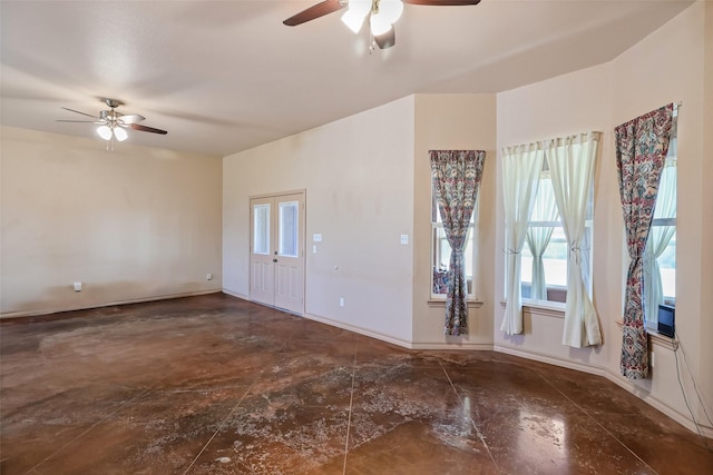 spare room featuring baseboards and ceiling fan