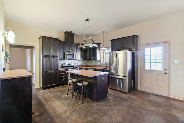 kitchen with a sink, plenty of natural light, tasteful backsplash, and appliances with stainless steel finishes