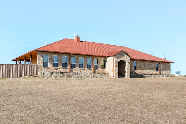 view of front of home featuring metal roof and stone siding