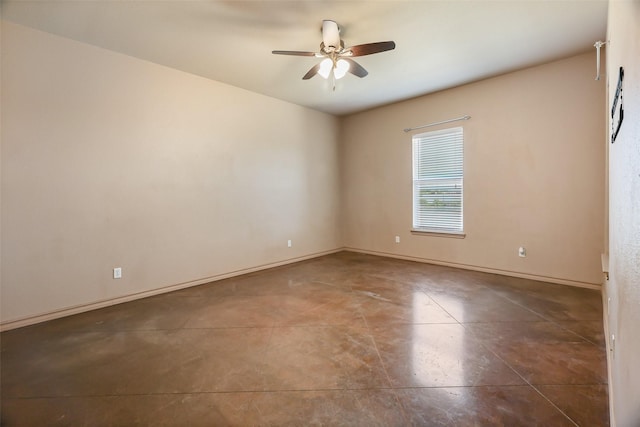 empty room featuring baseboards, concrete flooring, and a ceiling fan