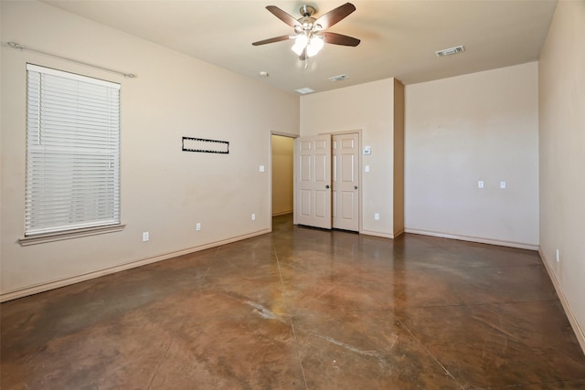 unfurnished bedroom featuring visible vents, finished concrete flooring, ceiling fan, and baseboards