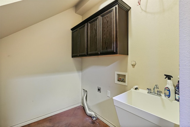 clothes washing area featuring dark tile patterned flooring, hookup for an electric dryer, a sink, cabinet space, and washer hookup