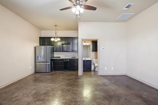 kitchen featuring concrete flooring, stainless steel fridge, a sink, baseboards, and visible vents