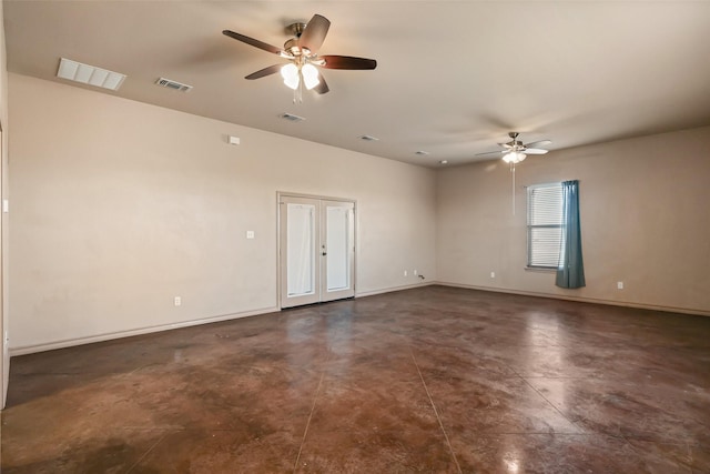 unfurnished room with visible vents, baseboards, concrete floors, and a ceiling fan