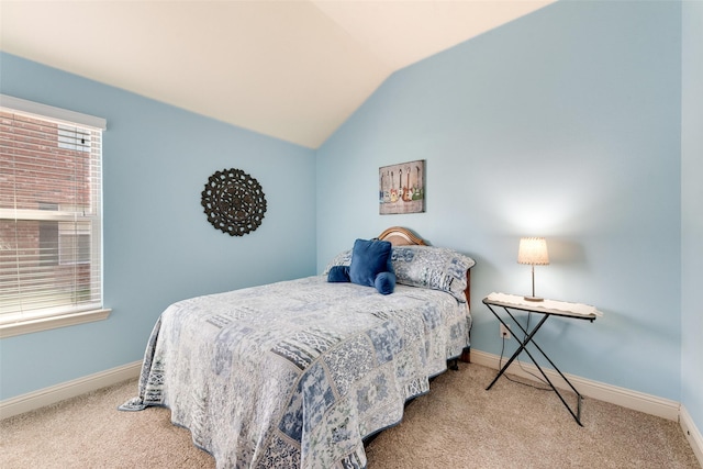 carpeted bedroom with vaulted ceiling and baseboards