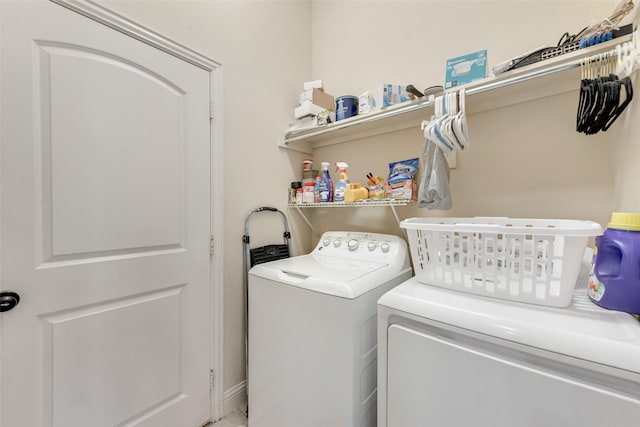 clothes washing area featuring laundry area and washer and clothes dryer