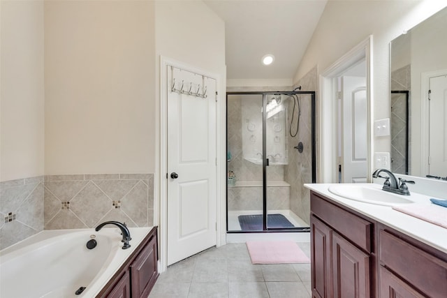 bathroom featuring tile patterned flooring, a garden tub, vanity, vaulted ceiling, and a stall shower