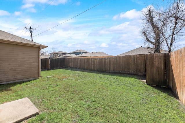 view of yard with a fenced backyard