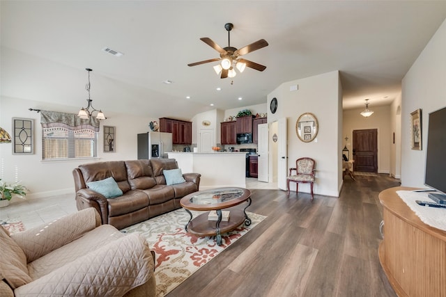 living room with recessed lighting, ceiling fan with notable chandelier, dark wood-type flooring, visible vents, and vaulted ceiling