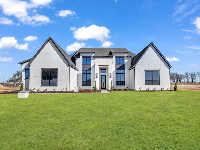 modern farmhouse featuring a front lawn