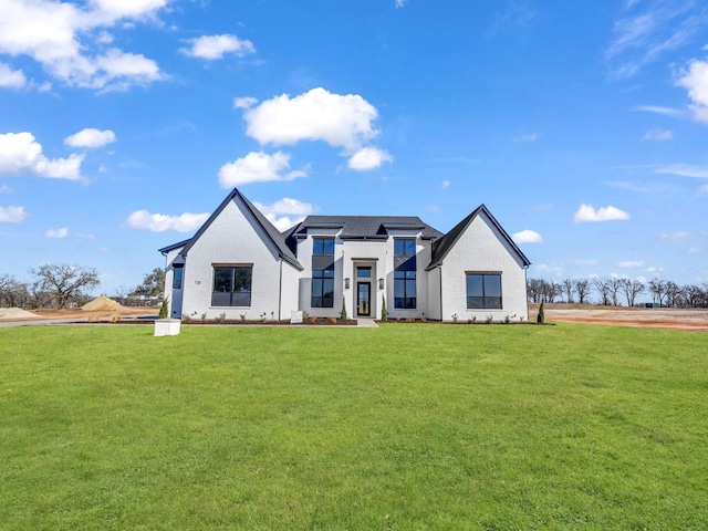 modern farmhouse with a front lawn