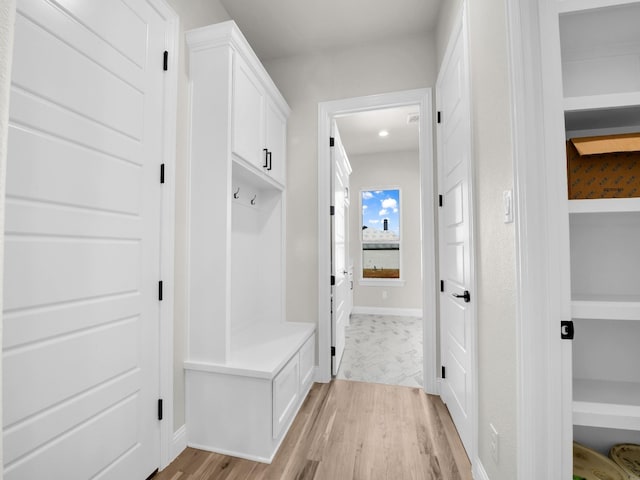 mudroom with baseboards and light wood finished floors