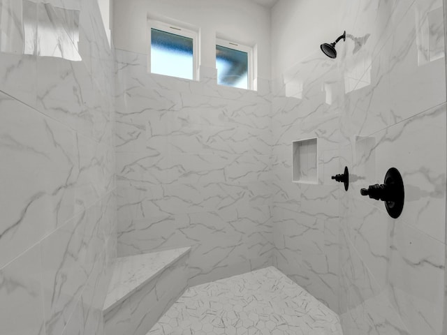 bathroom featuring a marble finish shower