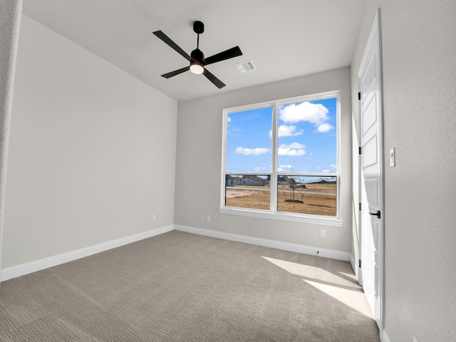 unfurnished room with light carpet, baseboards, visible vents, and a ceiling fan