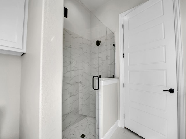 full bathroom with marble finish floor and a marble finish shower