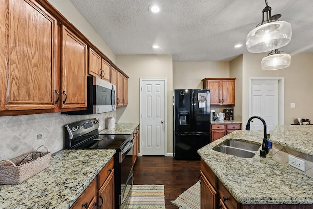 kitchen with decorative backsplash, brown cabinetry, appliances with stainless steel finishes, dark wood-type flooring, and a sink