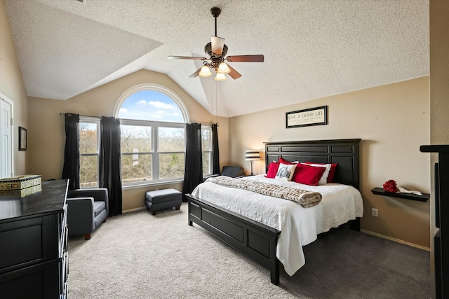 bedroom with ceiling fan, a textured ceiling, light colored carpet, baseboards, and vaulted ceiling