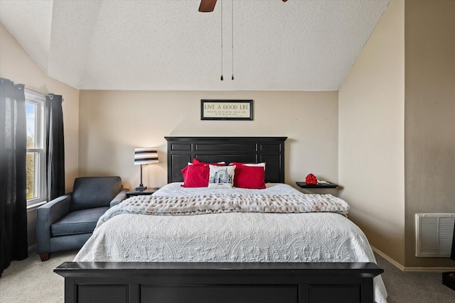 carpeted bedroom featuring visible vents, vaulted ceiling, a textured ceiling, ceiling fan, and baseboards