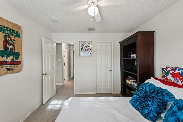 bedroom featuring visible vents, carpet flooring, ceiling fan, a textured ceiling, and baseboards