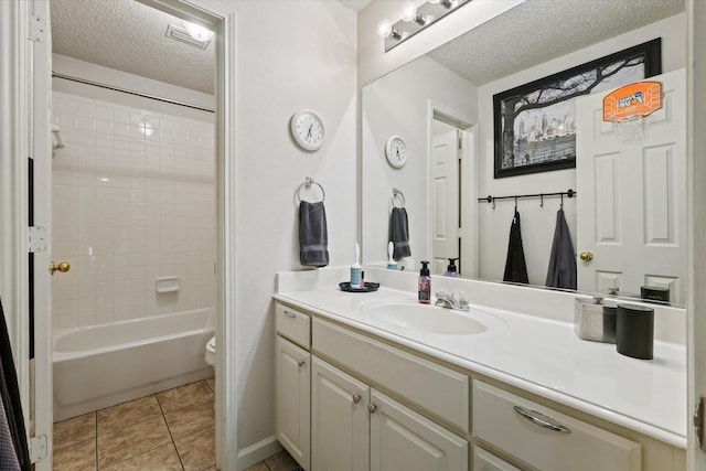 full bathroom featuring bathing tub / shower combination, toilet, a textured ceiling, vanity, and tile patterned flooring