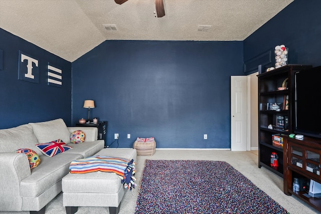 carpeted living area featuring lofted ceiling, ceiling fan, a textured ceiling, and visible vents