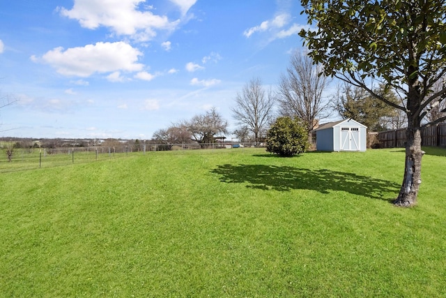 view of yard featuring a fenced backyard, an outdoor structure, and a storage shed