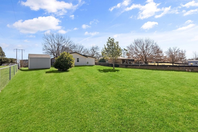 view of yard featuring a fenced backyard, an outdoor structure, and a storage shed